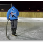 Volunteer flooding the rink